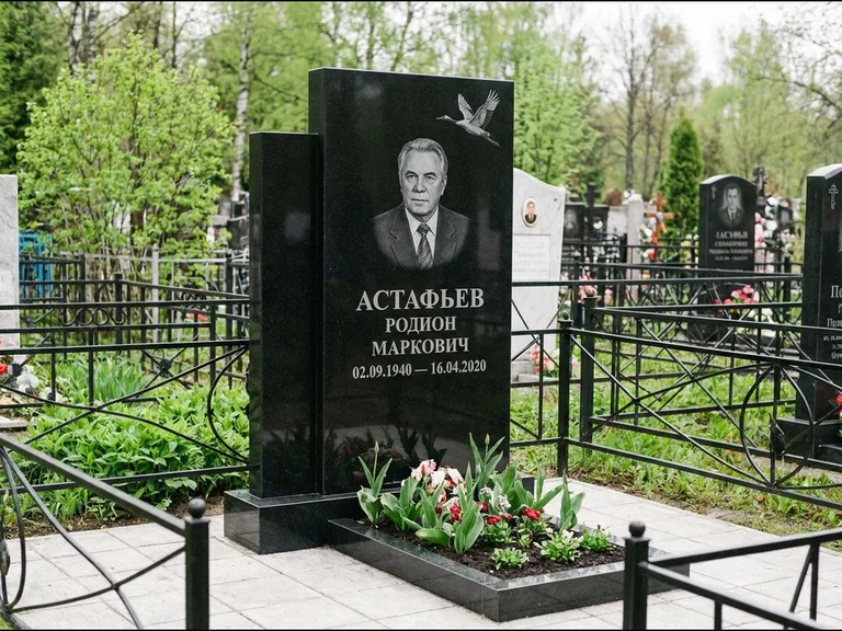Памятник с гравировкой журавлей — гравировка одиночного летящего журавля над портретом, работа «Астафьев» в Красноярске